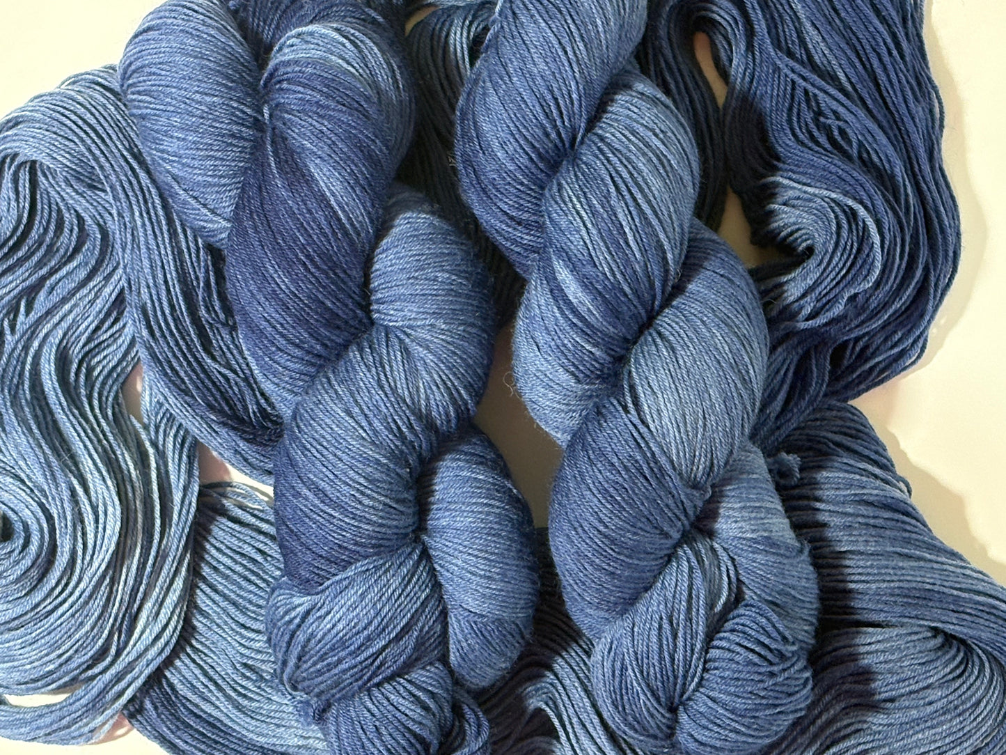 A deep, tonal blue hand-dyed yarn inspired by the quiet moment when daylight fades and night settles in.
