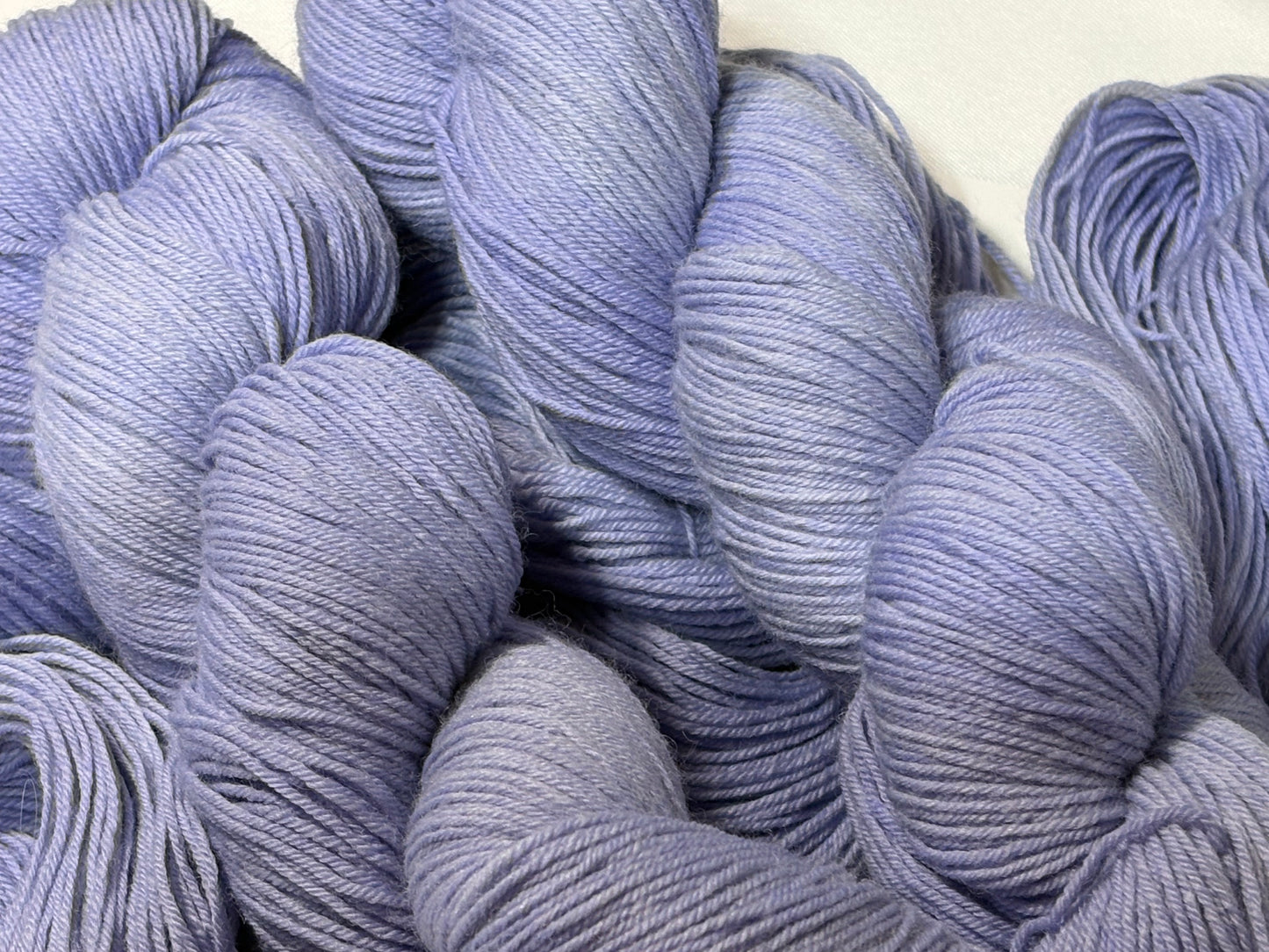 A soft lavender hand-dyed tonal yarn with gentle depth and a calm, misty finish. Wisteria Fog is quiet, elegant, and endlessly wearable.