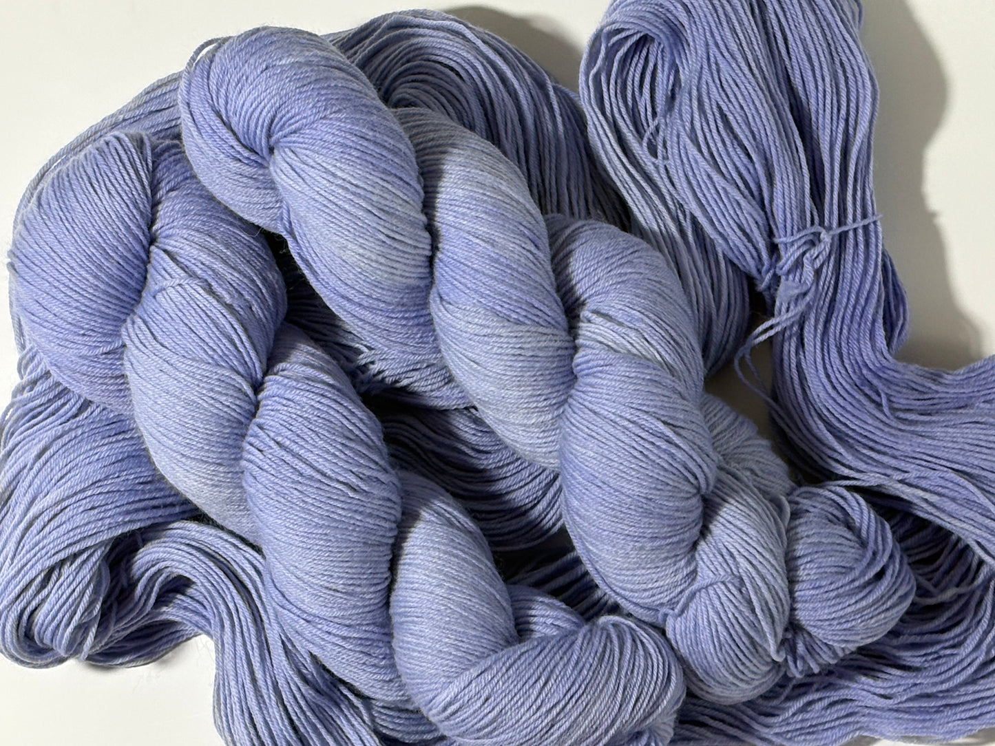 A soft lavender hand-dyed tonal yarn with gentle depth and a calm, misty finish. Wisteria Fog is quiet, elegant, and endlessly wearable.