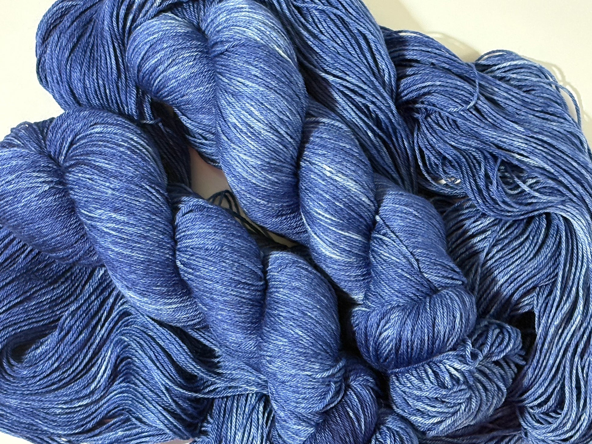 A deep, tonal blue hand-dyed yarn inspired by the quiet moment when daylight fades and night settles in.