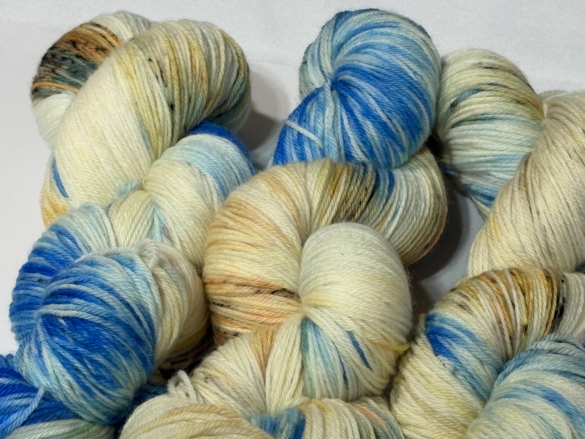 A wintery blend of pale blue, soft cream, and earthy speckles inspired by frost-covered branches. Frosted Branches is gentle, natural, and full of quiet detail.