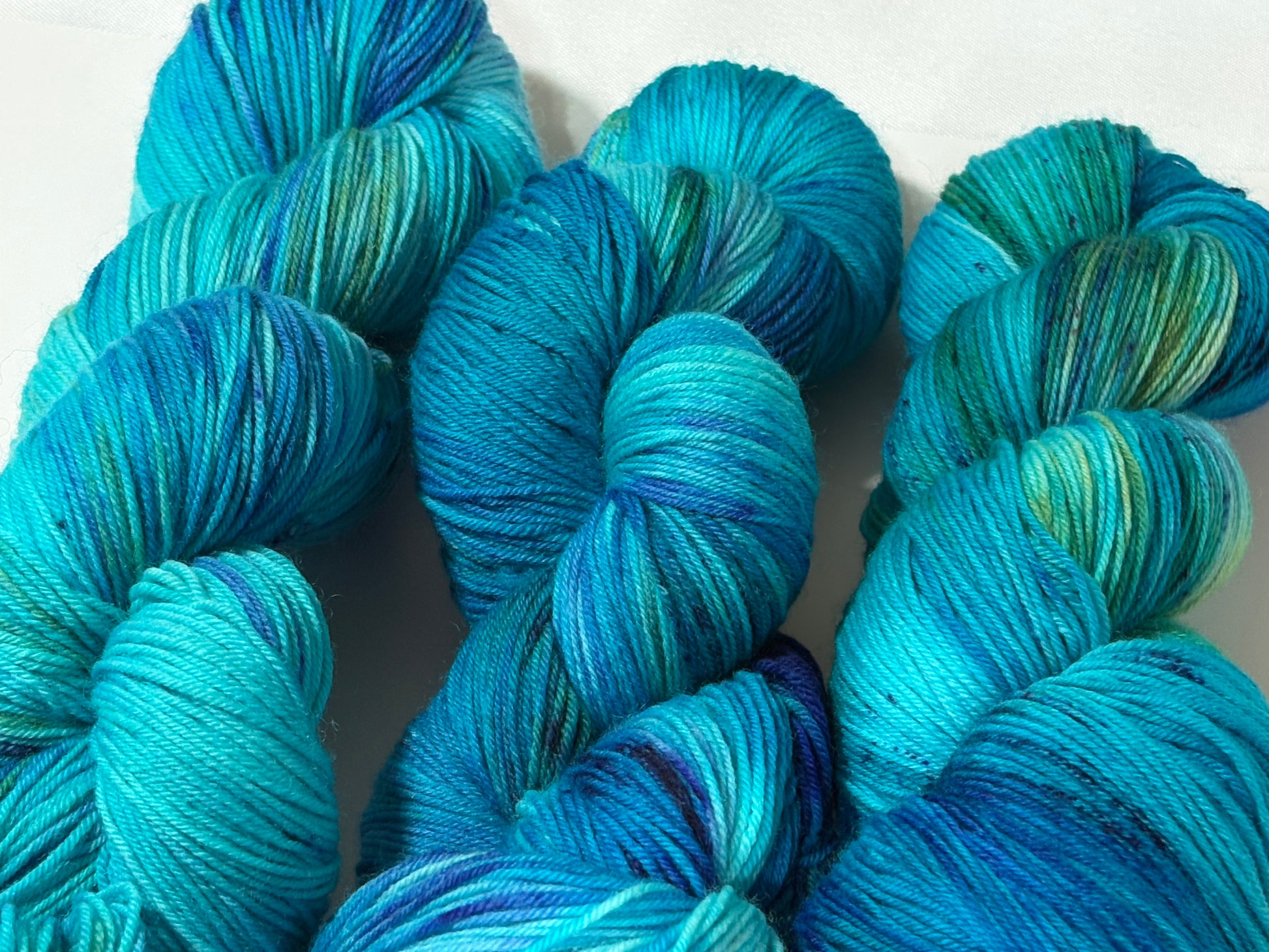 A flowing blend of teal, aqua, and deep blue inspired by winter rivers at dusk. Winter Twilight River is a hand-dyed yarn that is cool, dynamic, and full of movement.