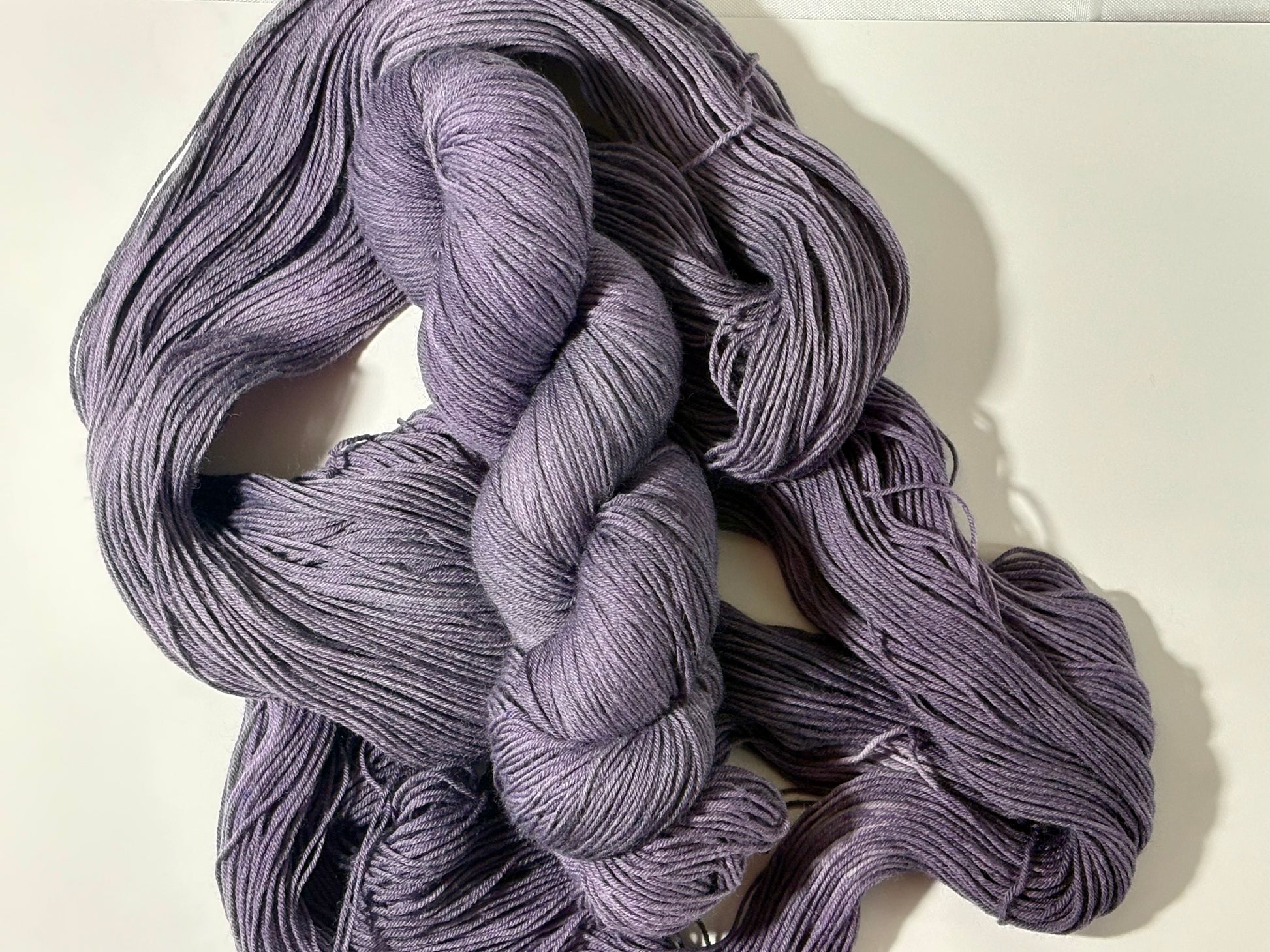 A smoky, softened violet indie-dyed yarn with subtle gray undertones, Nightfall Violet captures the hush of dusk as daylight fades into evening. Calm, contemplative, and endlessly wearable.
