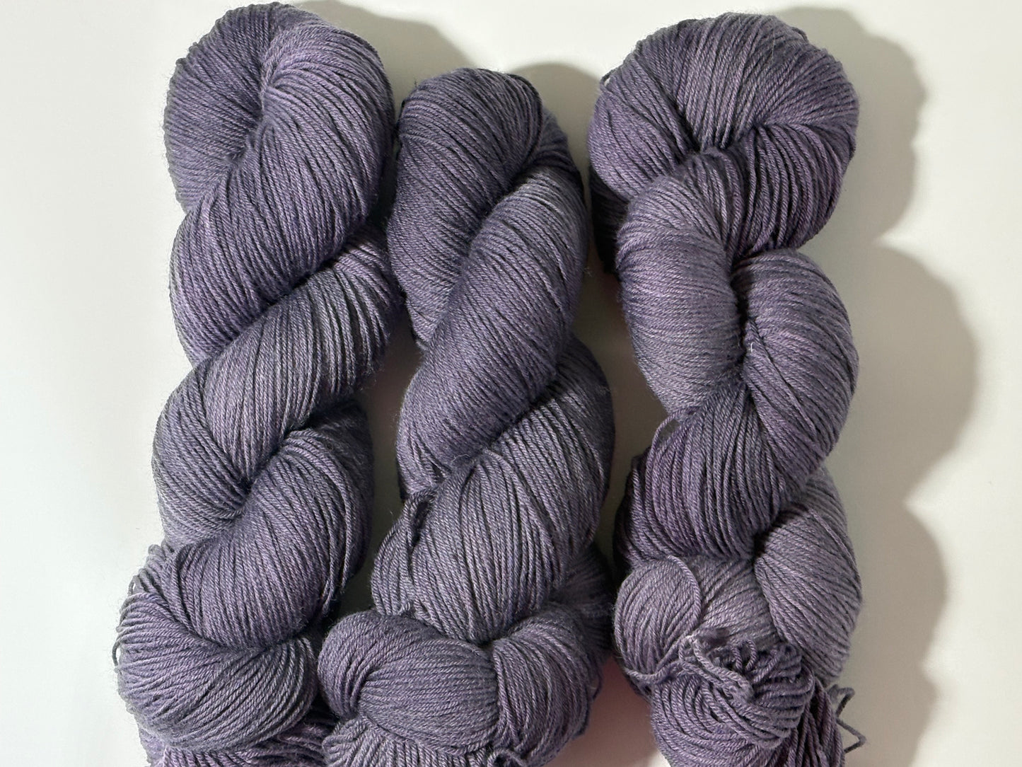 A smoky, softened violet indie-dyed yarn with subtle gray undertones, Nightfall Violet captures the hush of dusk as daylight fades into evening. Calm, contemplative, and endlessly wearable.