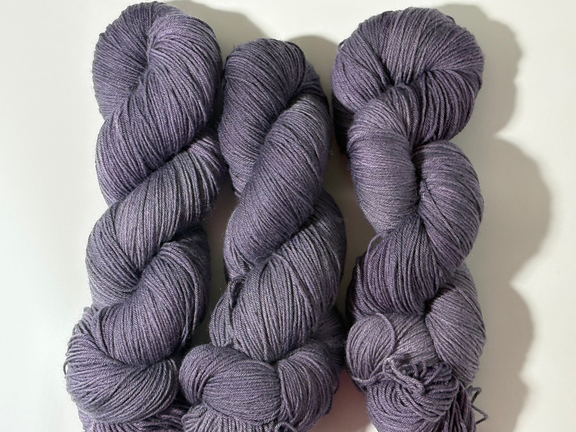 A smoky, softened violet indie-dyed yarn with subtle gray undertones, Nightfall Violet captures the hush of dusk as daylight fades into evening. Calm, contemplative, and endlessly wearable.