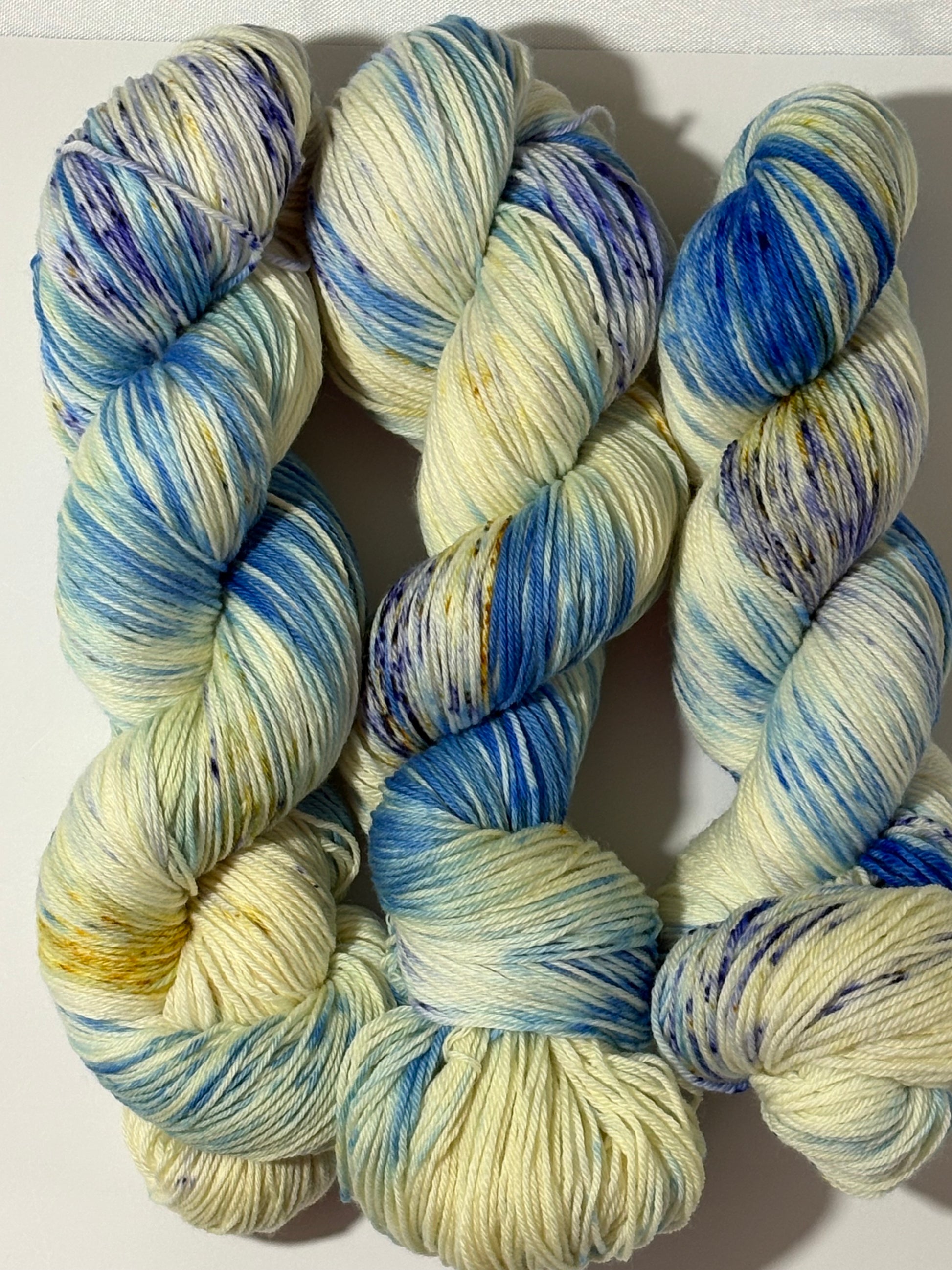 A softly speckled winter hand-dyed yarn colorway inspired by quiet woodland paths dusted with frost and snow.