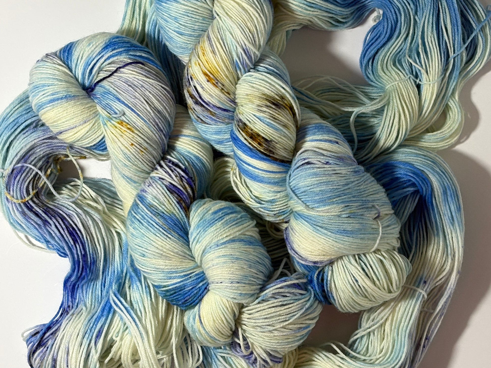 A softly speckled winter hand-dyed yarn colorway inspired by quiet woodland paths dusted with frost and snow.