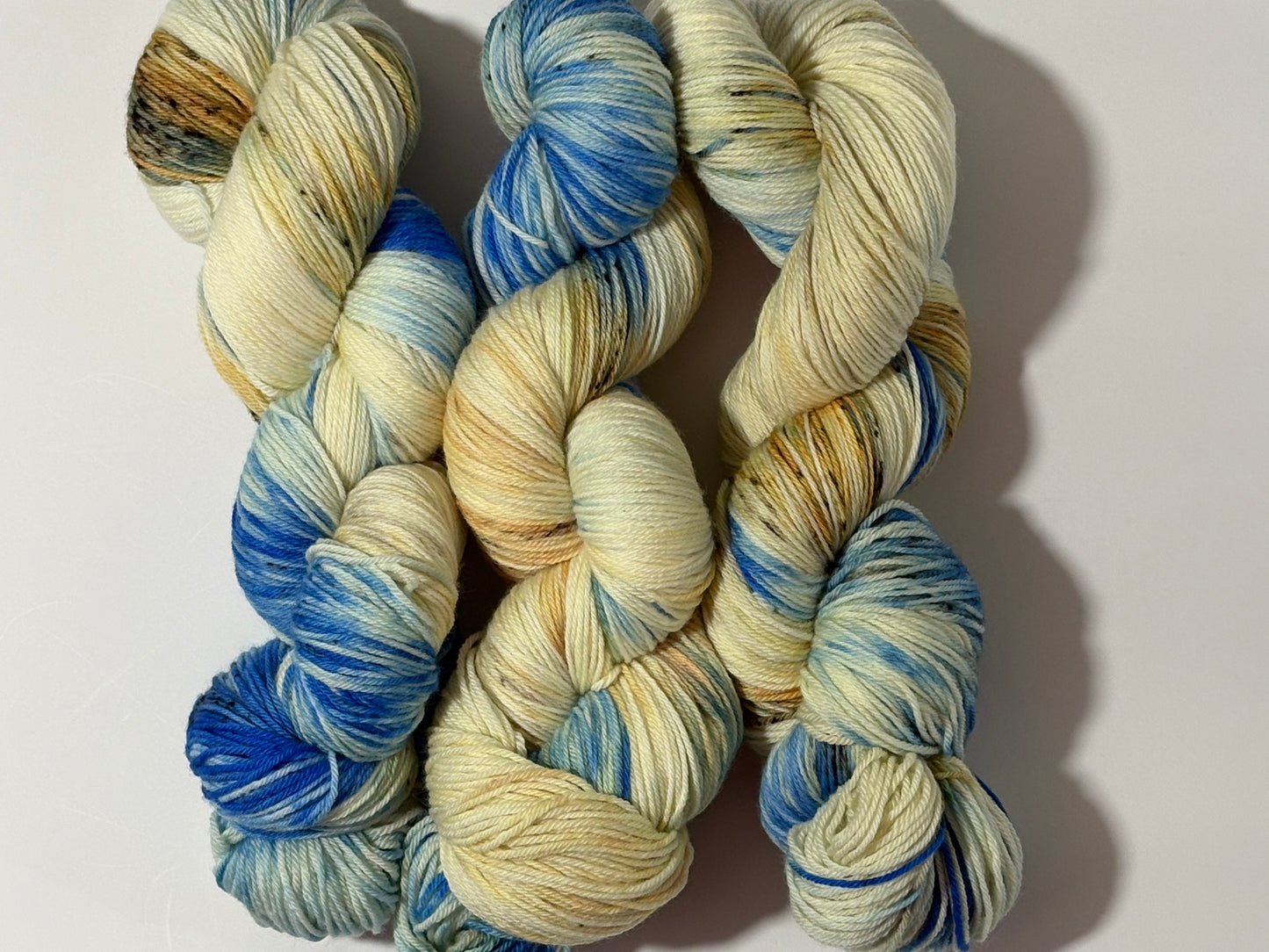 A wintery blend of pale blue, soft cream, and earthy speckles inspired by frost-covered branches. Frosted Branches is gentle, natural, and full of quiet detail.