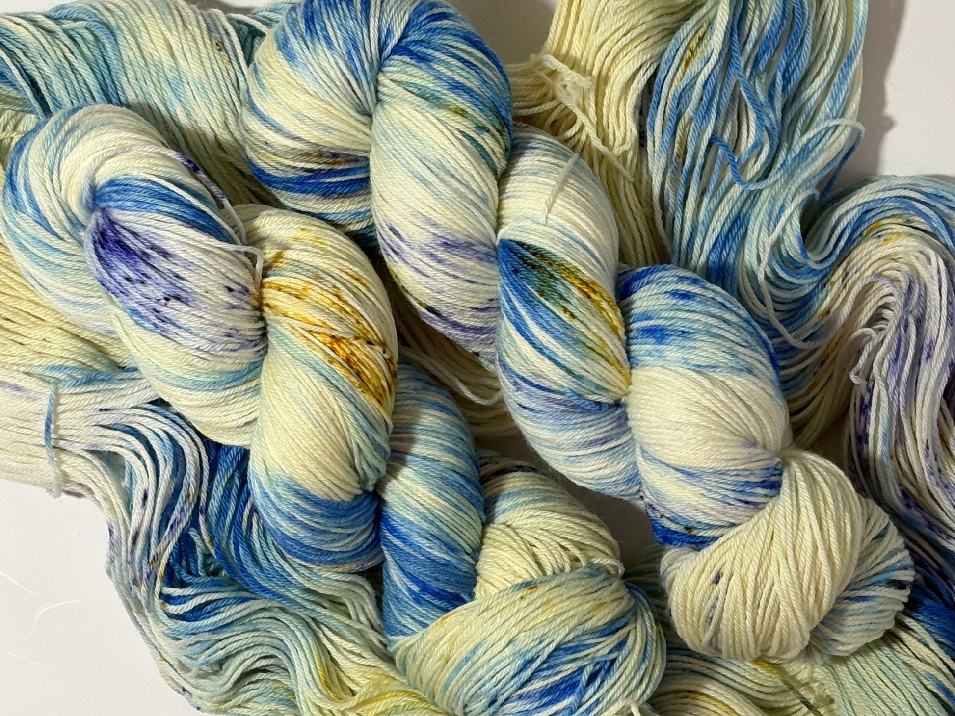 A softly speckled winter hand-dyed yarn colorway inspired by quiet woodland paths dusted with frost and snow.