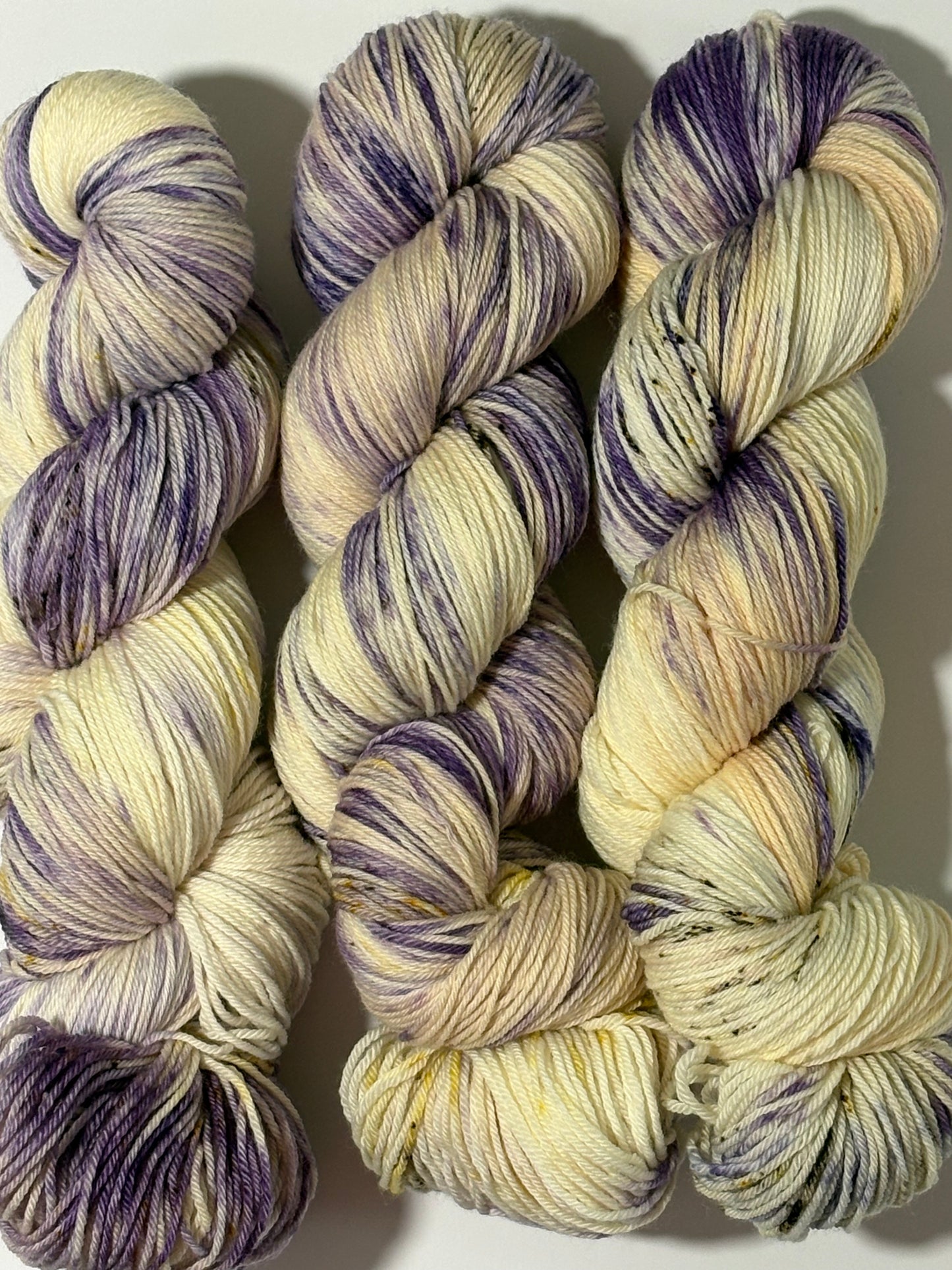 A luminous cream base multicolored hand-dyed yarn brushed with soft lilac and delicate golden speckles. Enchanted Winterlight captures the quiet magic of winter light through old glass.