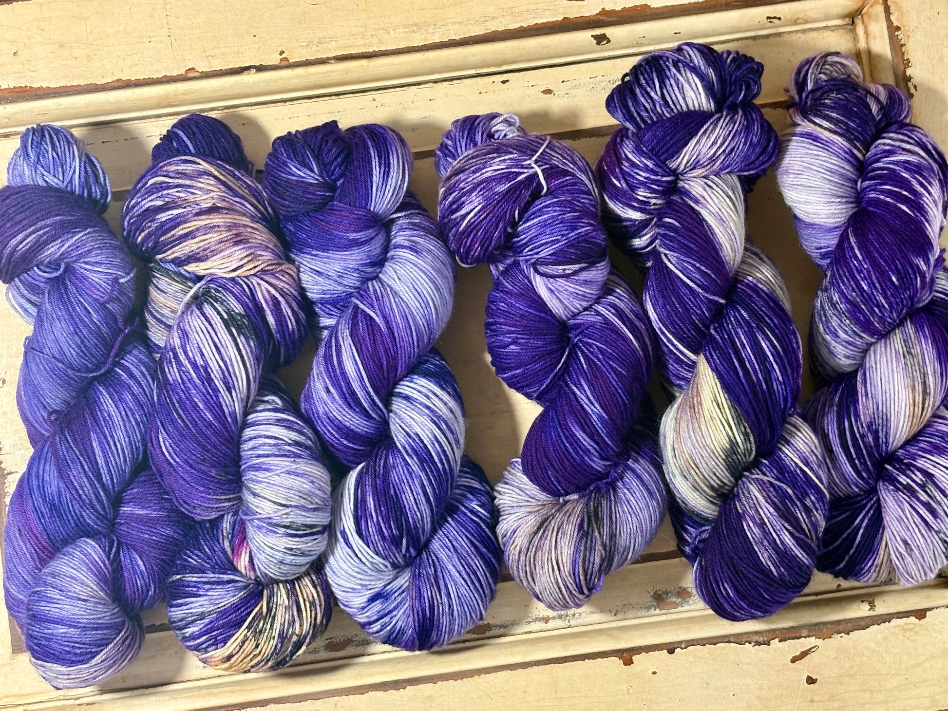 Amethyst Frost by The Curious Skein — an indie dyed multicolored yarn inspired by the glow of twilight on freshly fallen snow. Hand-dyed merino nylon fingering weight for knitting and crochet.