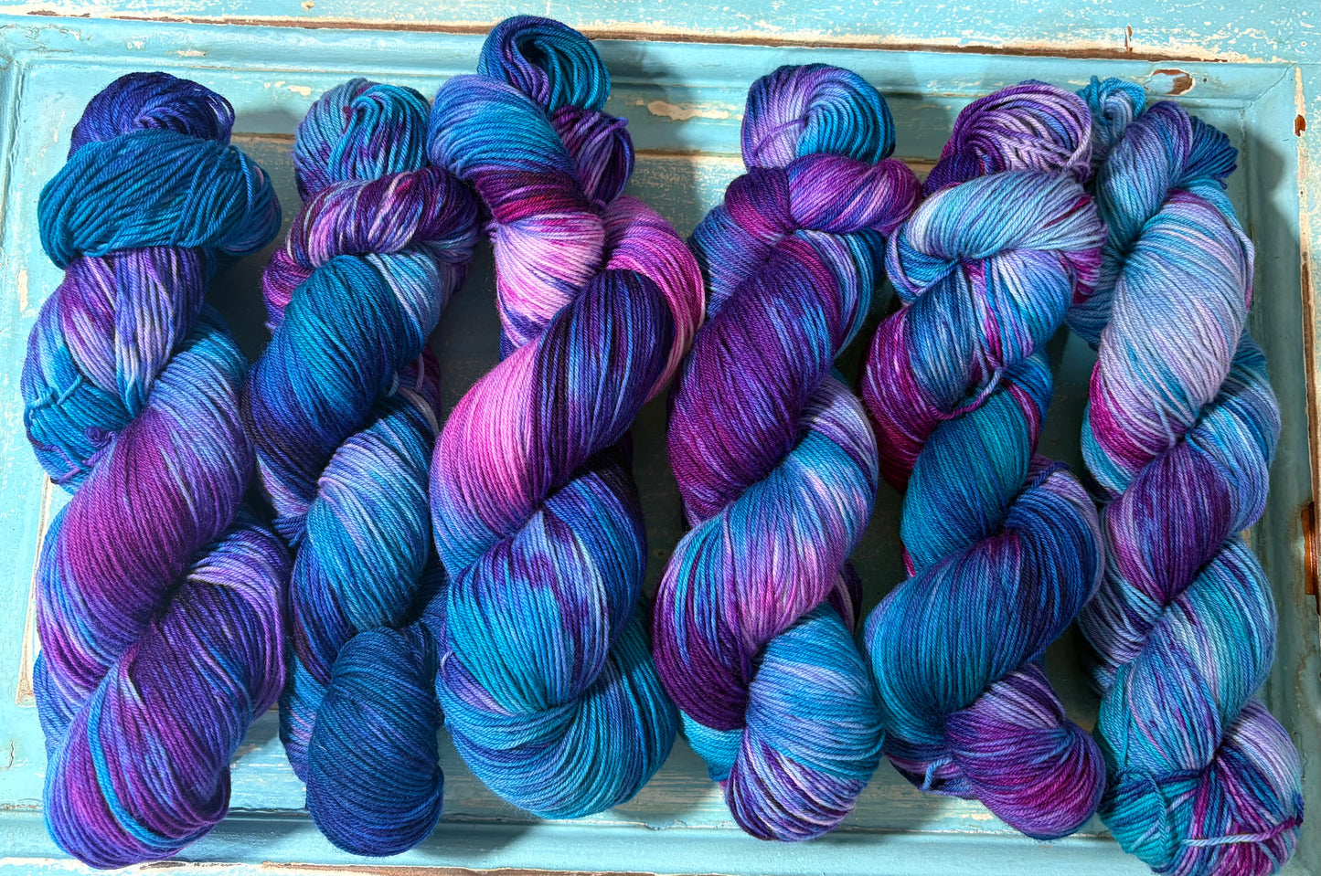 Hand-dyed yarn in Arctic Frost- fingering weight merino nylon blend in frosty blue, pink and purple.
