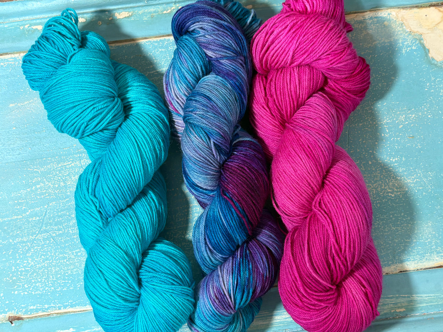 Hand-dyed yarn in Glacial Blue, Arctic Frost and Frosted Pink- fingering weight merino nylon blend in frosty blues, pinks and purples. Perfect pairing for multi skein projects.