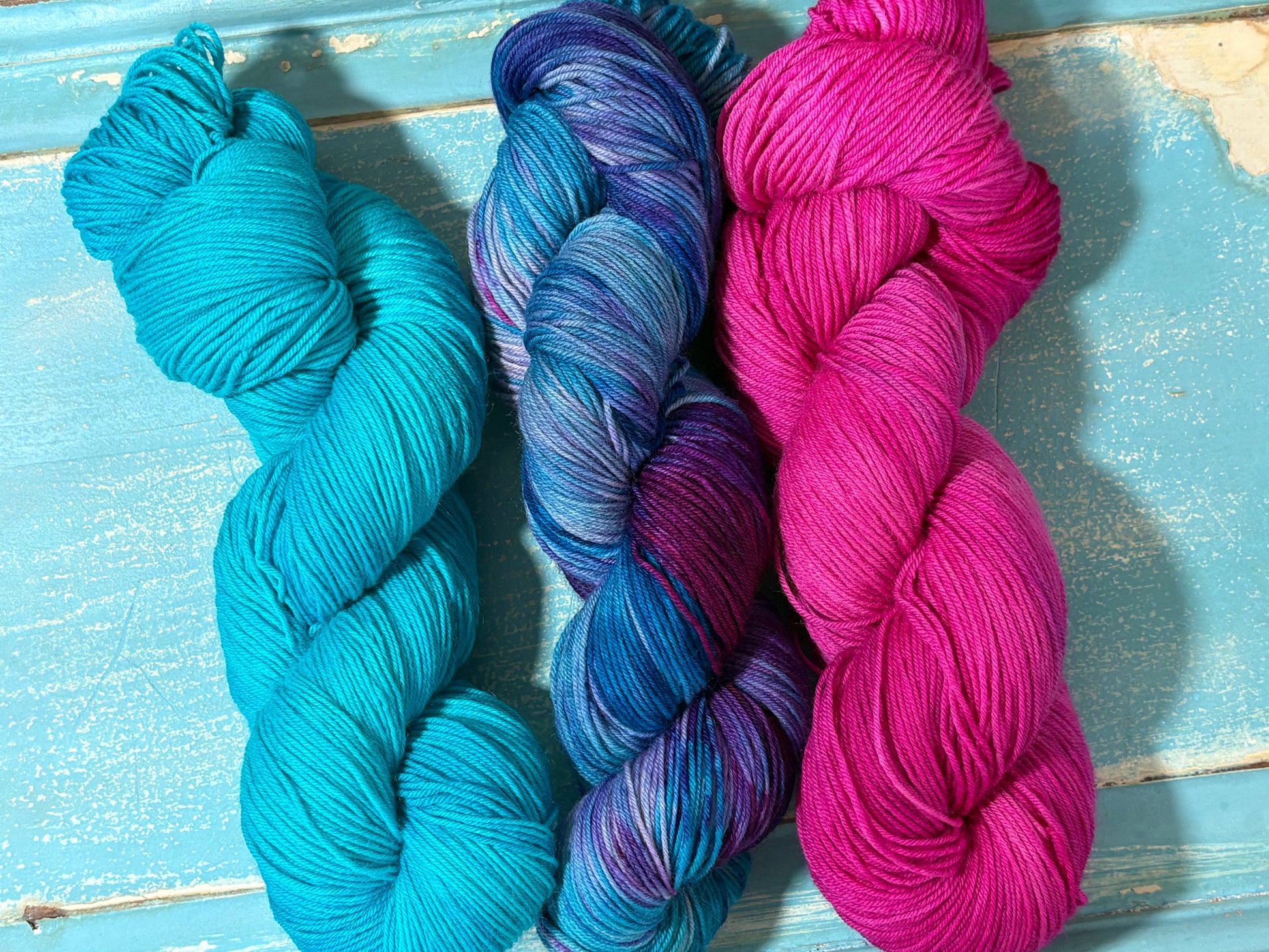 Hand-dyed yarn in Glacial Blue, Arctic Frost and Frosted Pink- fingering weight merino nylon blend in frosty blues, pinks and purples. Perfect pairing for multi skein projects.