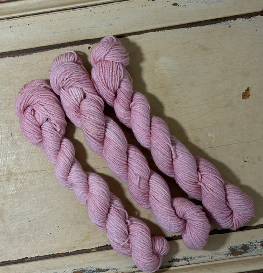 Hand-dyed yarn in Blushed Petal by The Curious Skein - 80% merino wool/ 20% nylon. Inspired by dusty rose petals.