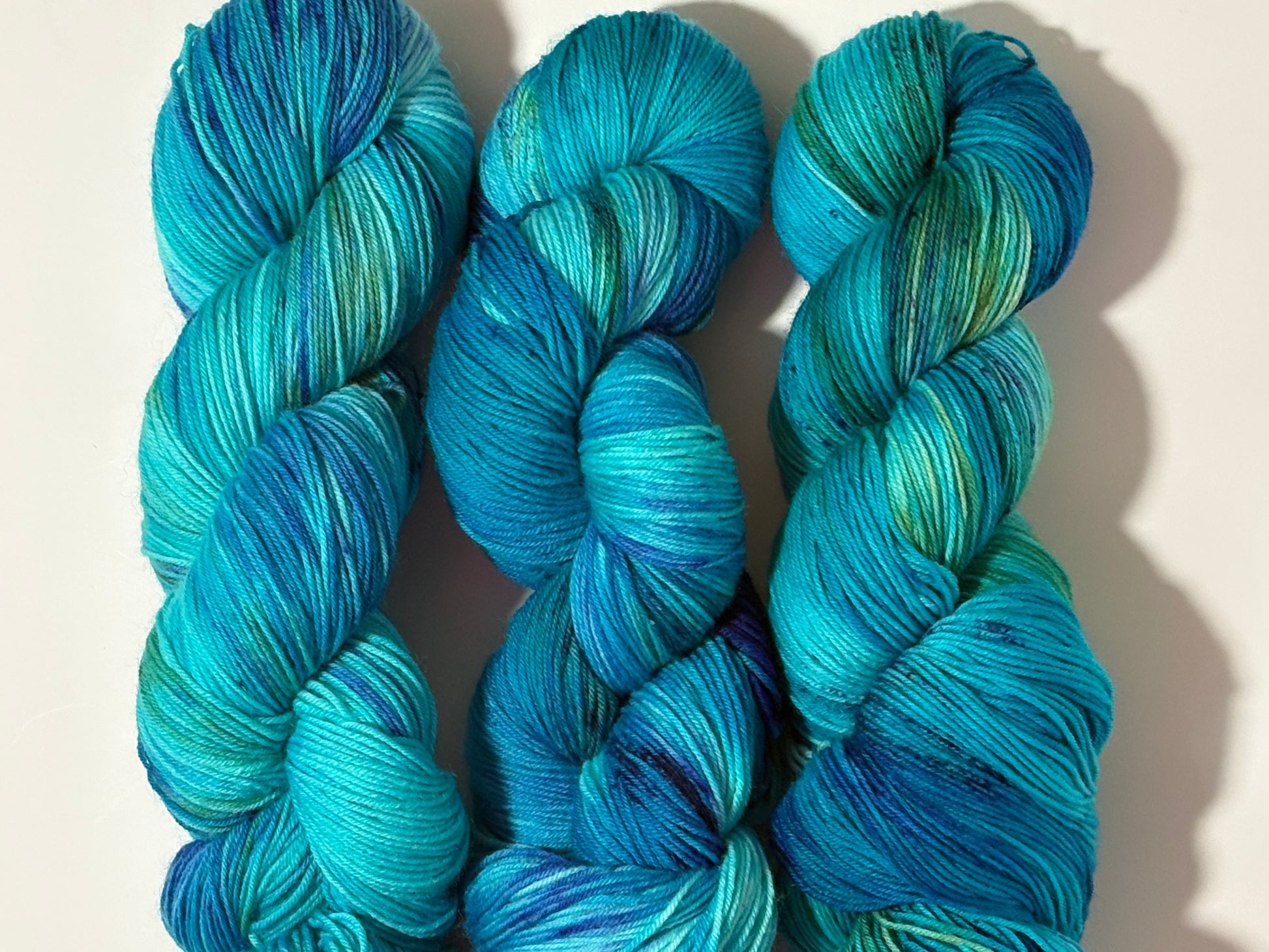 A flowing blend of teal, aqua, and deep blue inspired by winter rivers at dusk. Winter Twilight River is a hand-dyed yarn that is cool, dynamic, and full of movement.