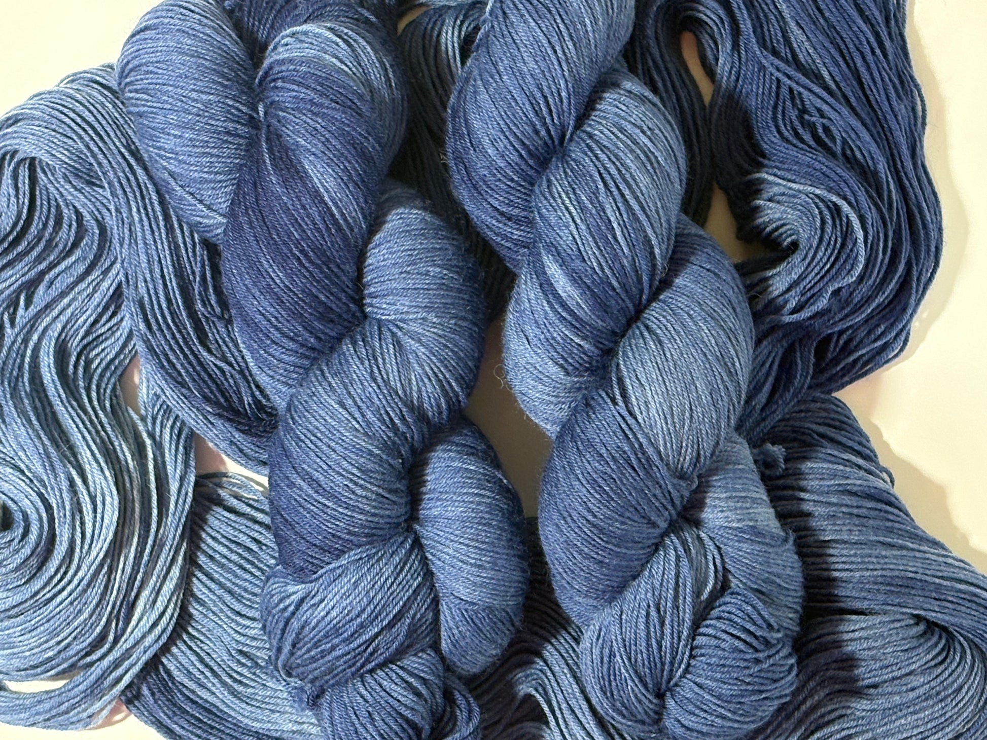 A deep, tonal blue hand-dyed yarn inspired by the quiet moment when daylight fades and night settles in.