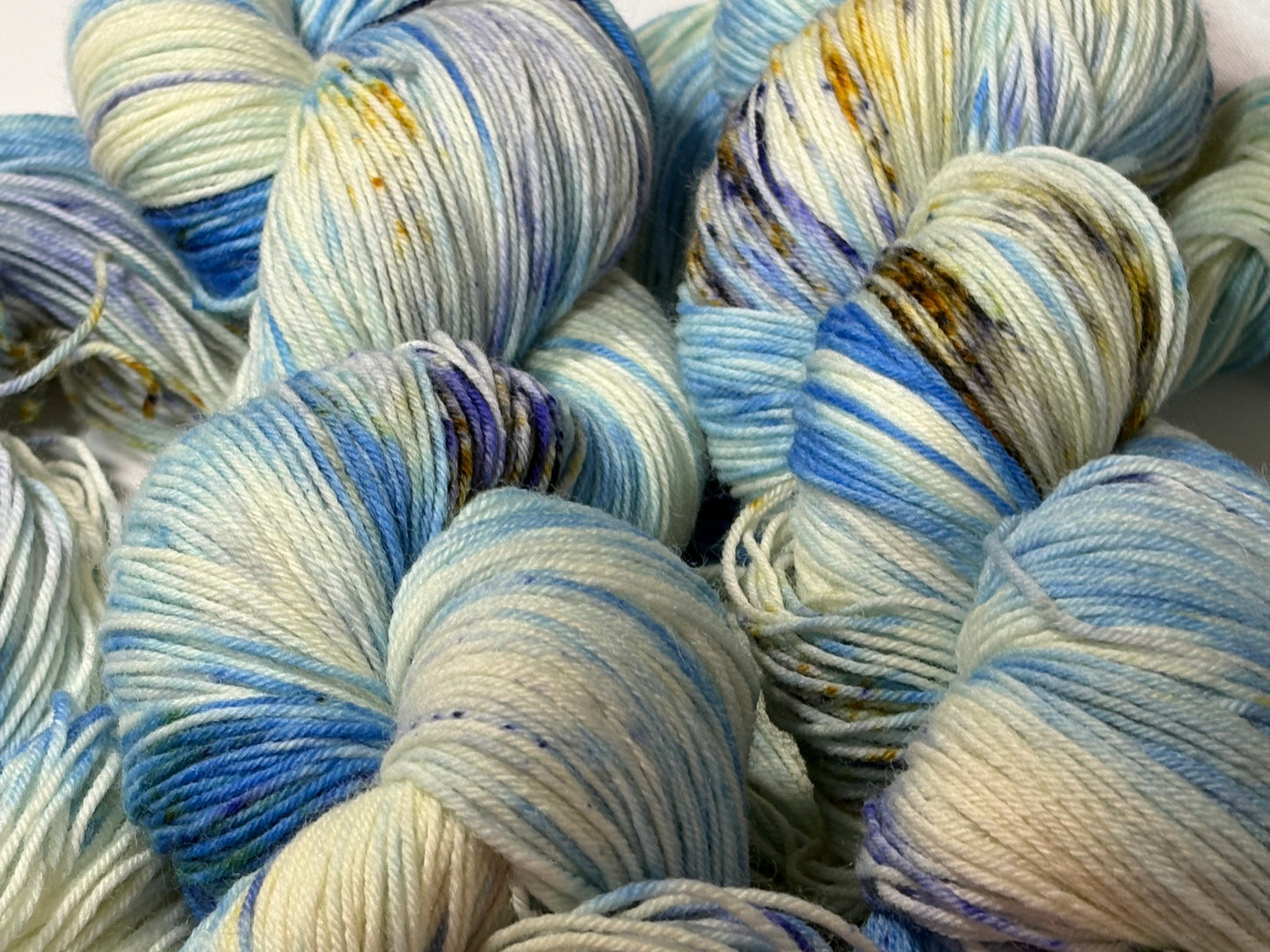 A softly speckled winter hand-dyed yarn colorway inspired by quiet woodland paths dusted with frost and snow.