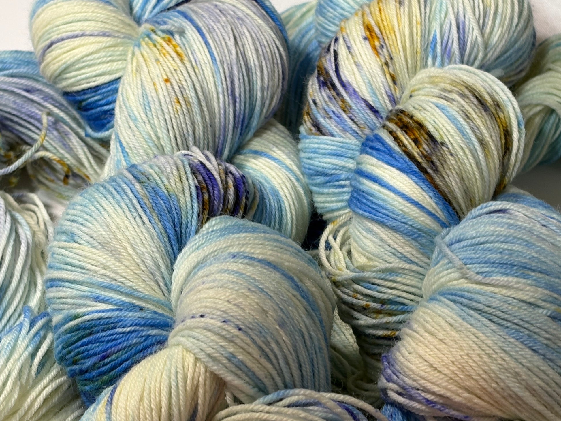 A softly speckled winter hand-dyed yarn colorway inspired by quiet woodland paths dusted with frost and snow.