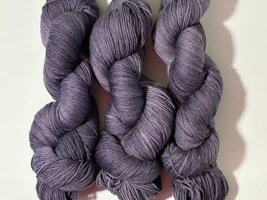 A smoky, softened violet hand-dyed tonal yarn with subtle gray undertones, Nightfall Violet captures the hush of dusk as daylight fades into evening. Calm, contemplative, and endlessly wearable.