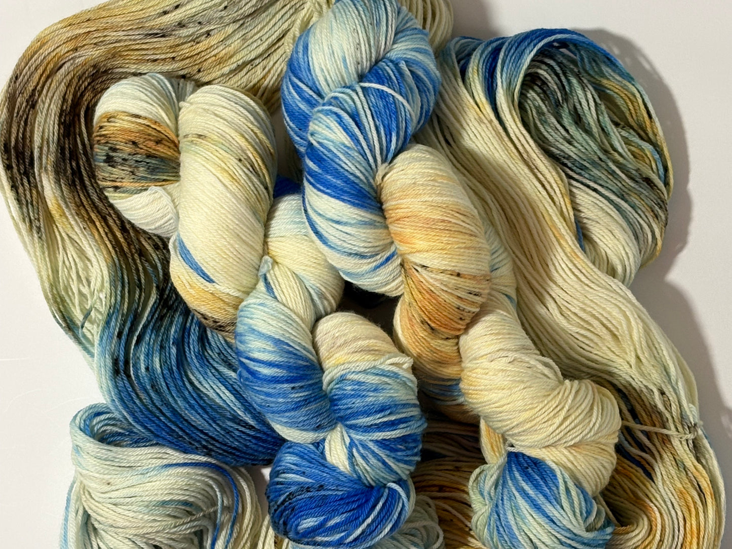 A wintery blend of pale blue, soft cream, and earthy speckles inspired by frost-covered branches. Frosted Branches is gentle, natural, and full of quiet detail.