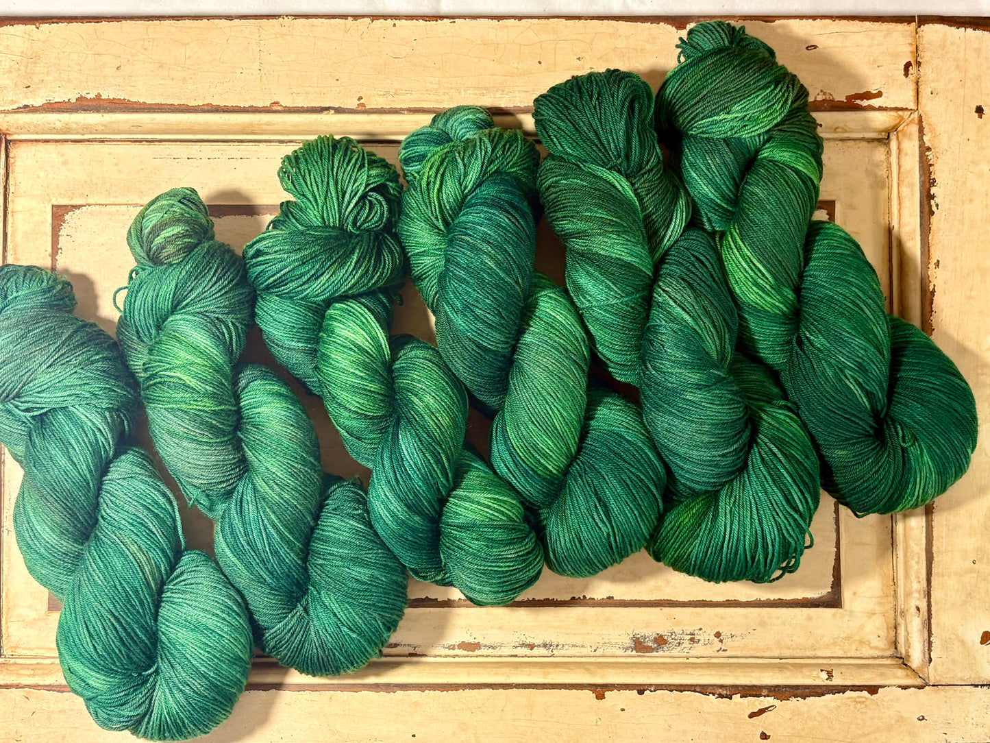 Discover Evergreen Glow — a hand-dyed tonal yarn by The Curious Skein. Small batch, luxury merino wool fingering weight yarn for knitting and crochet.