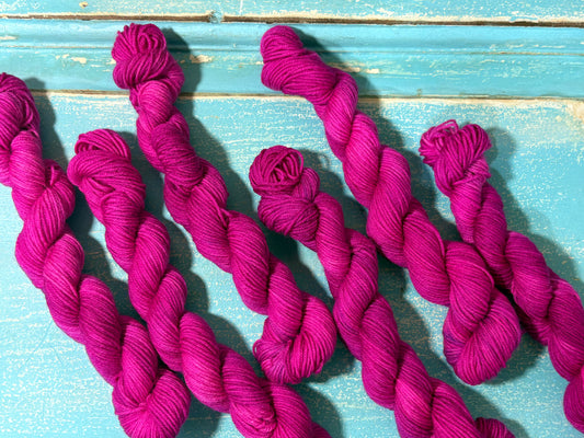 Discover Frosted Rose — a hand-dyed tonal yarn mini skein by The Curious Skein. Small batch, luxury merino nylon fingering weight yarn for knitting and crochet.