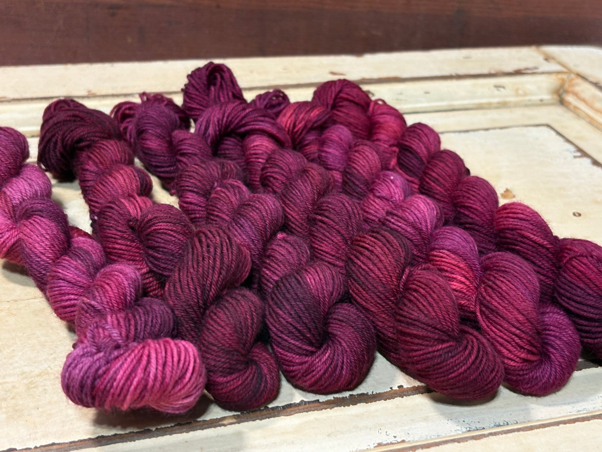 Garnet Hollow by The Curious Skein — a one-of-a-kind hand-dyed yarn. Unique small batch merino nylon fingering weight artisan yarn for knit 