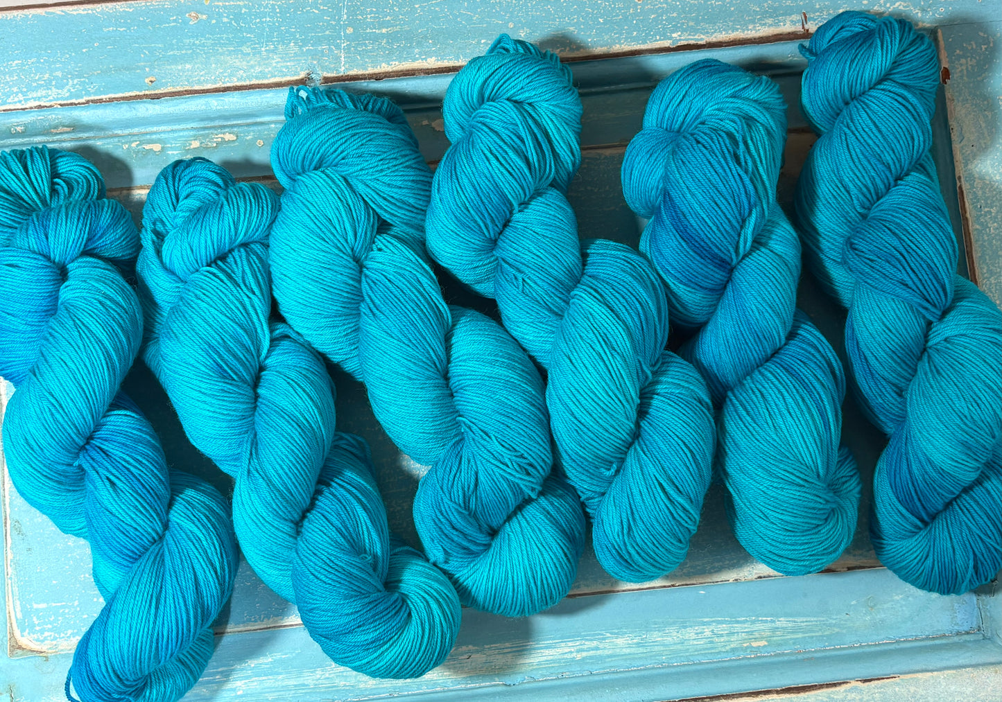 Discover Glacial Blue — a hand-dyed tonal yarn by The Curious Skein. Small batch, luxury merino nylon fingering weight yarn for knitting and crochet.