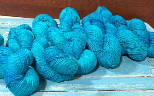 Discover Glacial Blue — a hand-dyed tonal yarn by The Curious Skein. Small batch, luxury merino nylon fingering weight yarn for knitting and crochet.