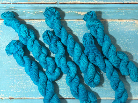 Discover Glacial Blue — a hand-dyed tonal mini skein yarn by The Curious Skein. Small batch, luxury merino nylon fingering weight yarn for knitting and crochet.