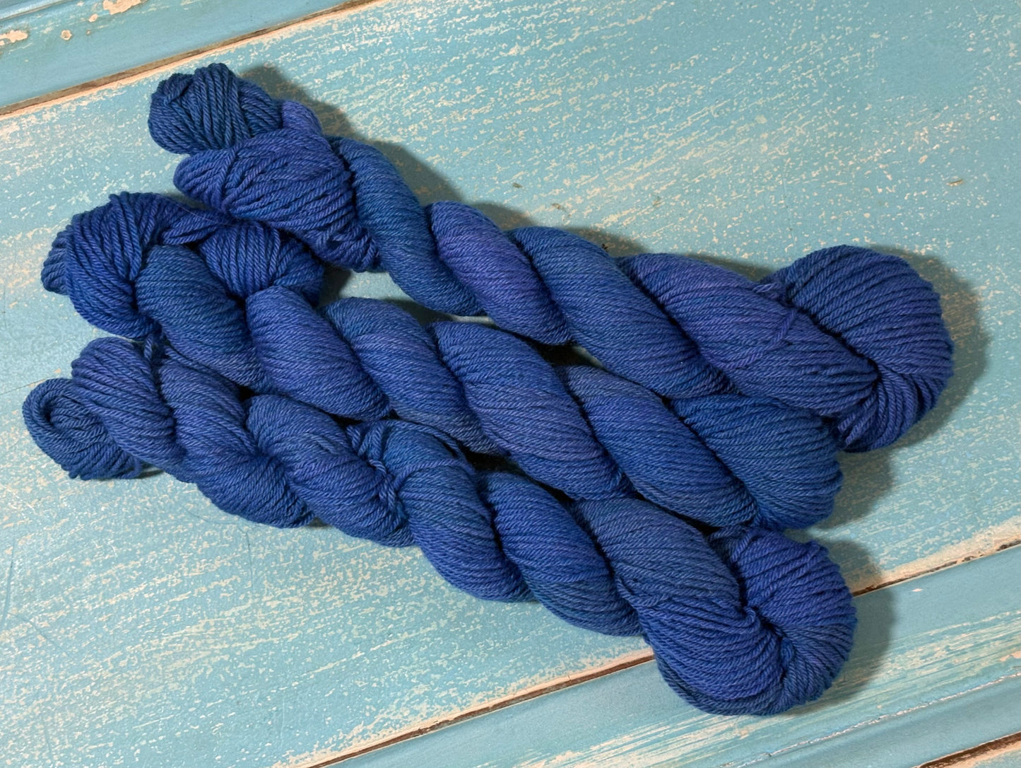 Hand-dyed tonal yarn in Inkwell Blue by The Curious Skein - 80% merino wool/ 20% nylon.