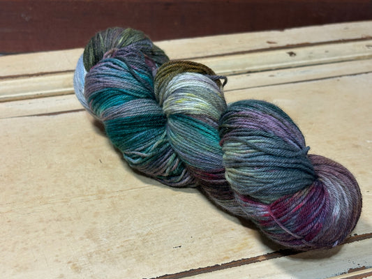 Hand-dyed yarn in Secret Grove by The Curious Skein - 80% merino wool/ 20% nylon. Inspired by moss and forest paths.