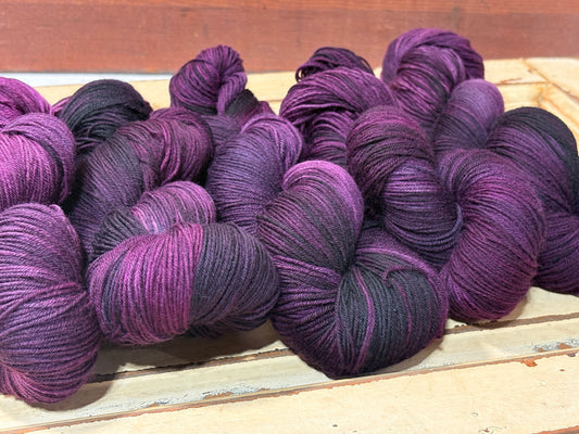 Discover Sugar Plum Velvet — a hand-dyed tonal yarn by The Curious Skein. Small batch, luxury merino wool fingering weight yarn for knitting and crochet.