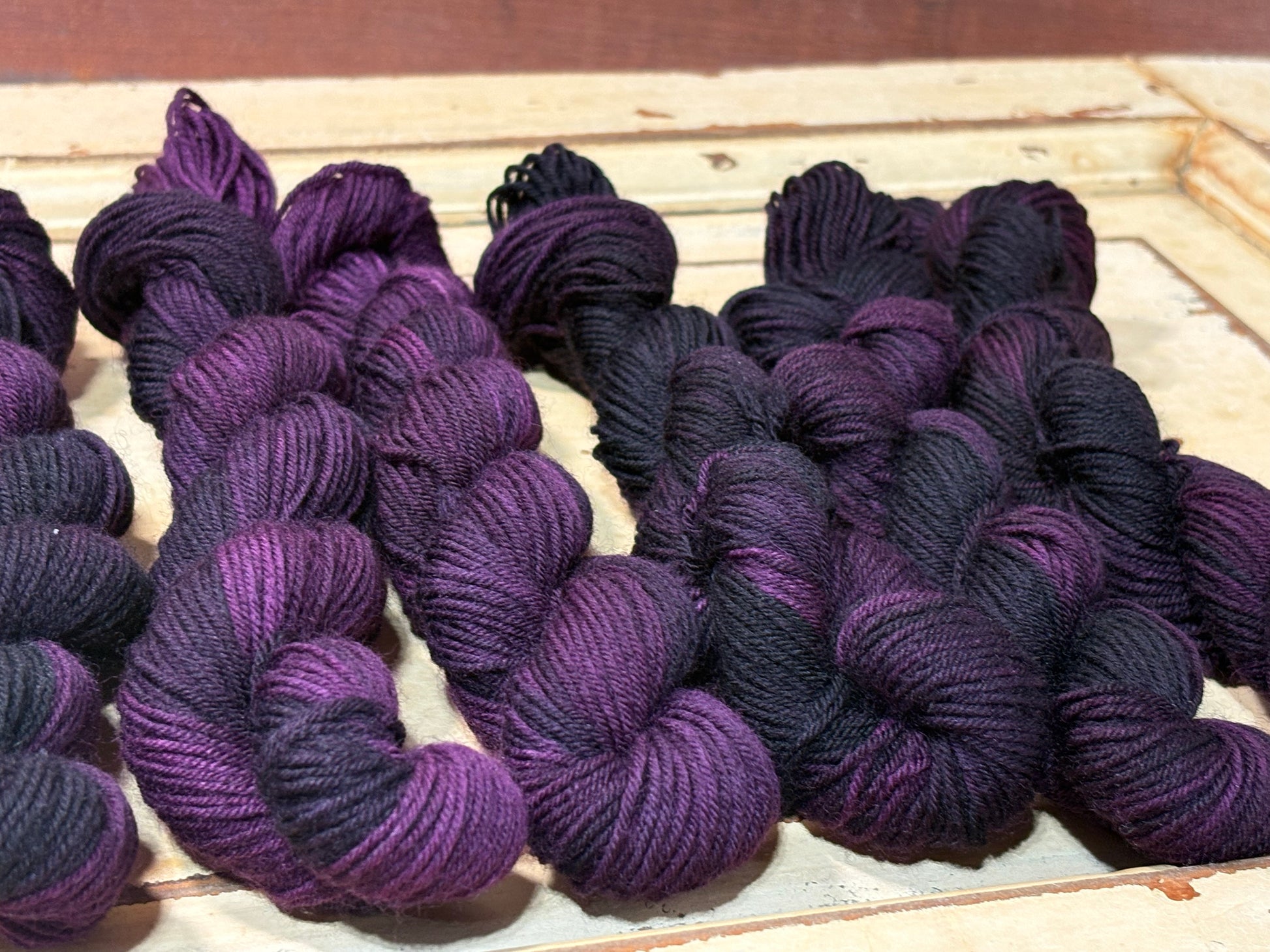 Discover Sugar Plum Velvet — a hand-dyed tonal yarn mini skein by The Curious Skein. Small batch, luxury merino wool fingering weight yarn for knitting and crochet.