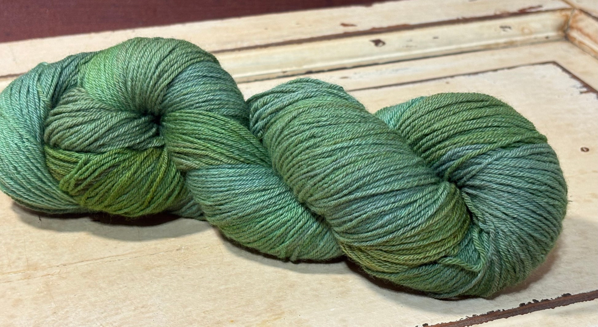 Hand-dyed yarn in Willowmere by The Curious Skein - 80% merino wool/ 20% nylon. Inspired by mossy greens.