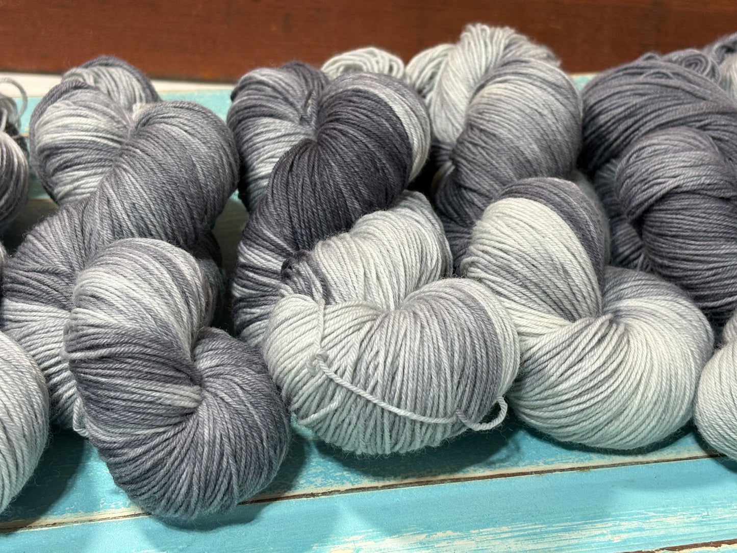 Winter's Breath by The Curious Skein — an indie dyed multicolored yarn inspired by warm breath meeting crisp winter air. Hand-dyed merino wool fingering weight yarn for knitting and crochet.