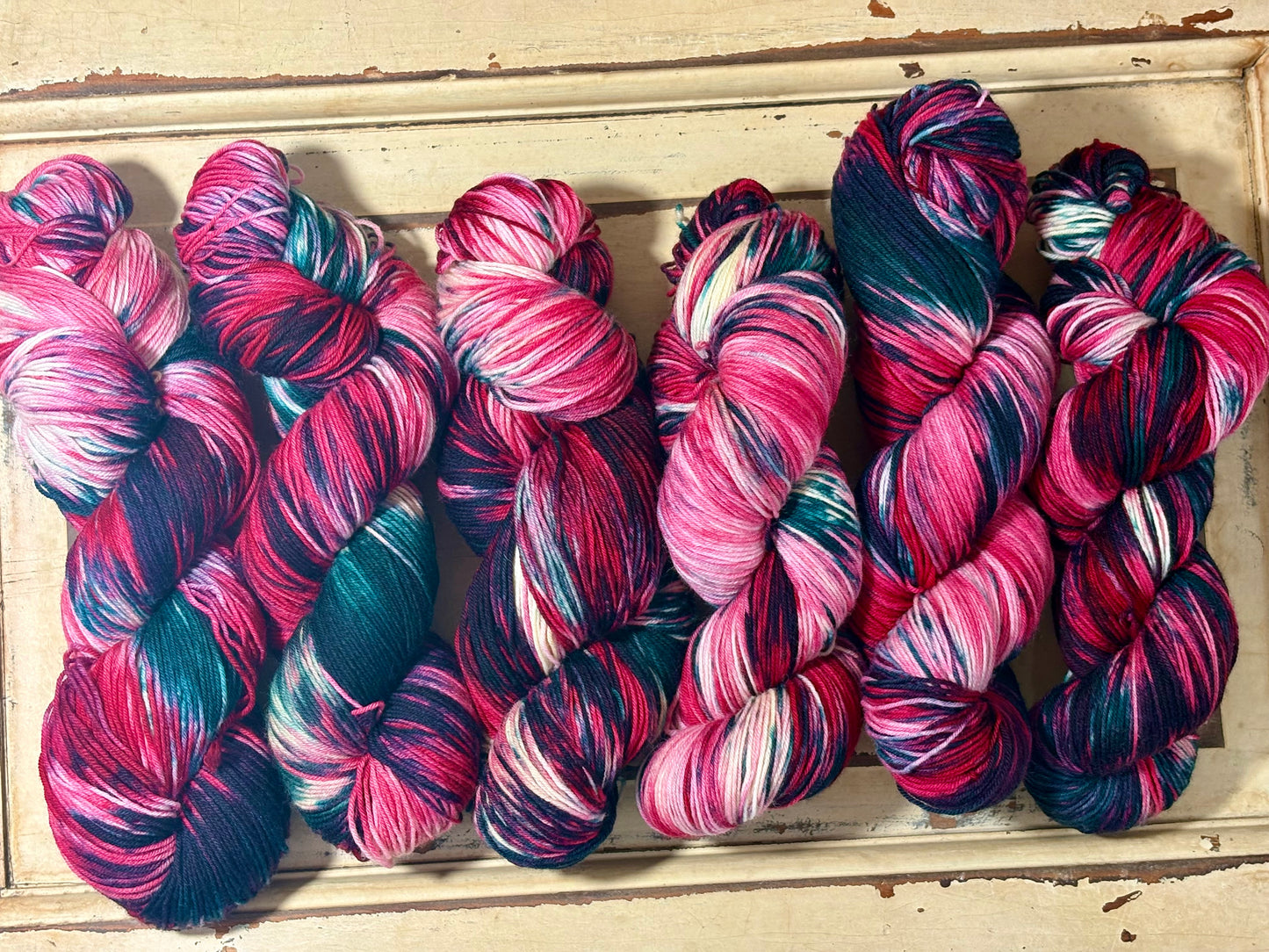 Winterberry Garland by The Curious Skein — an indie dyed multicolored yarn inspired by the magic of holiday color. Hand-dyed merino nylon fingering weight for knitting and crochet.