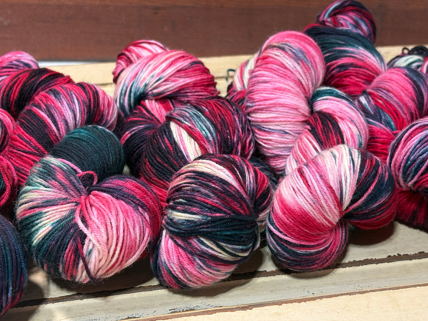 Winterberry Garland by The Curious Skein — an indie dyed multicolored yarn inspired by the magic of holiday color. Hand-dyed merino nylon fingering weight for knitting and crochet.