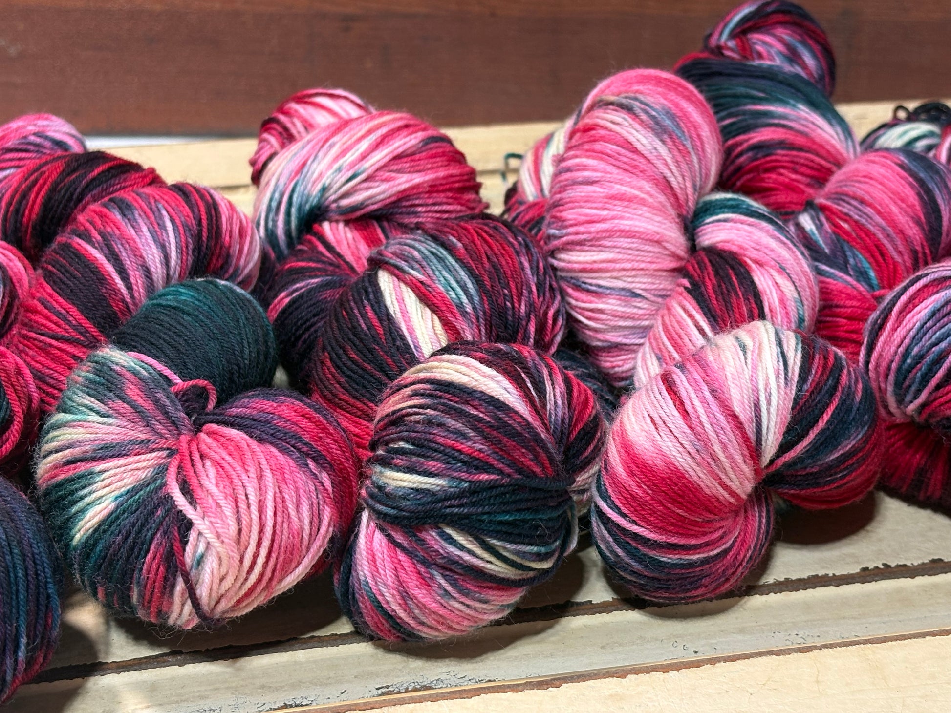 Winterberry Garland by The Curious Skein — an indie dyed multicolored yarn inspired by the magic of holiday color. Hand-dyed merino nylon fingering weight for knitting and crochet.
