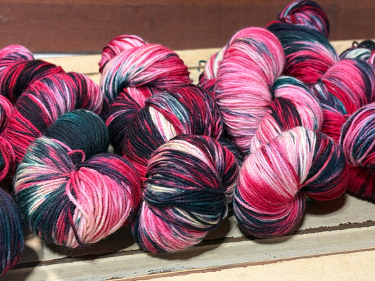 Winterberry Garland by The Curious Skein — an indie dyed multicolored yarn inspired by the magic of holiday color. Hand-dyed merino nylon fingering weight for knitting and crochet.