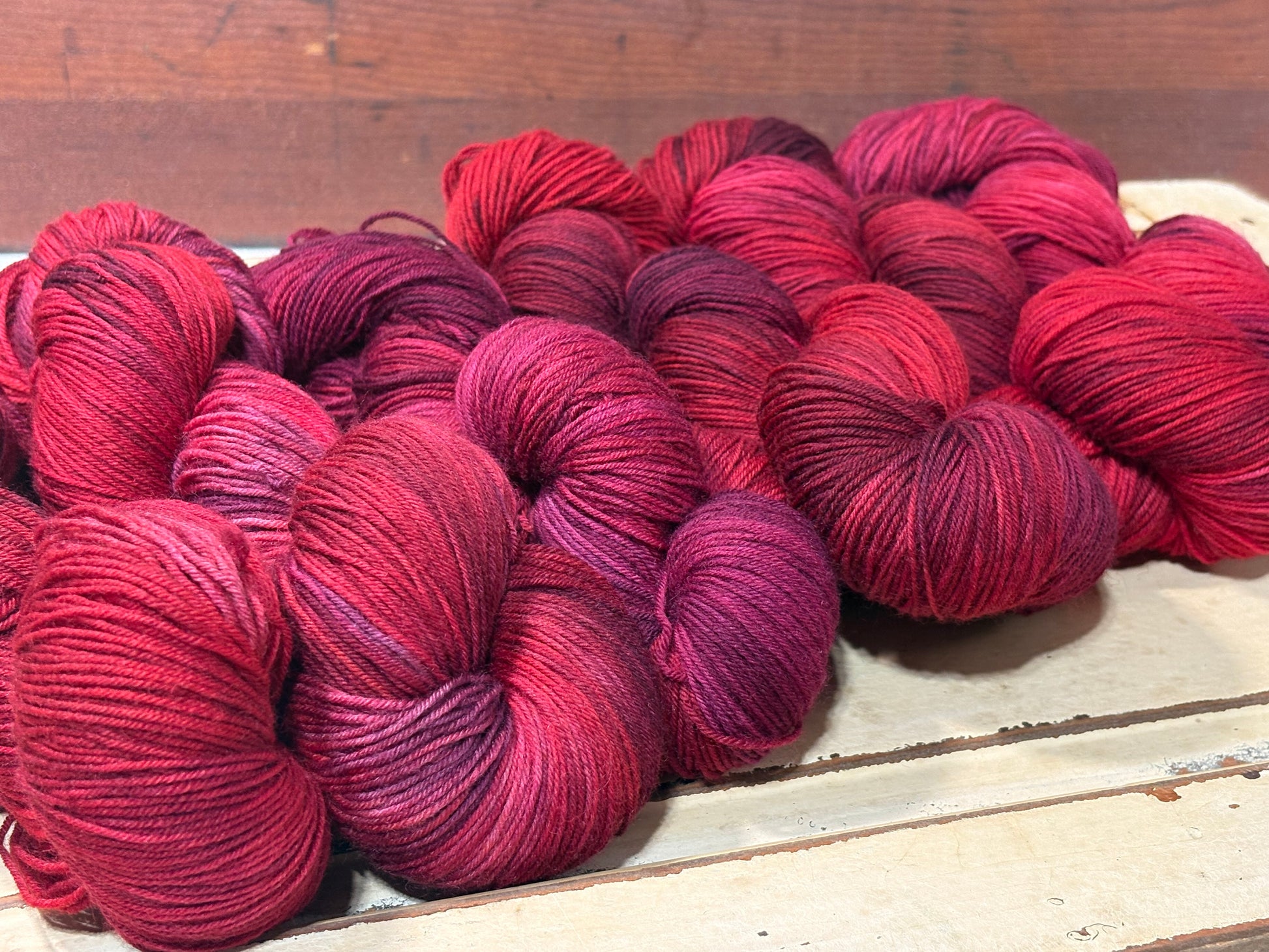 Discover Winterberry Red — a hand-dyed tonal yarn by The Curious Skein. Small batch, luxury merino wool fingering weight yarn for knitting and crochet.
