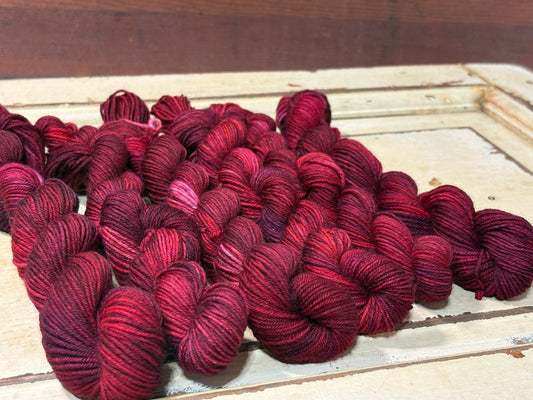 Discover Winterberry Red — a hand-dyed tonal yarn by The Curious Skein. Small batch, luxury merino wool fingering weight yarn for knitting and crochet.